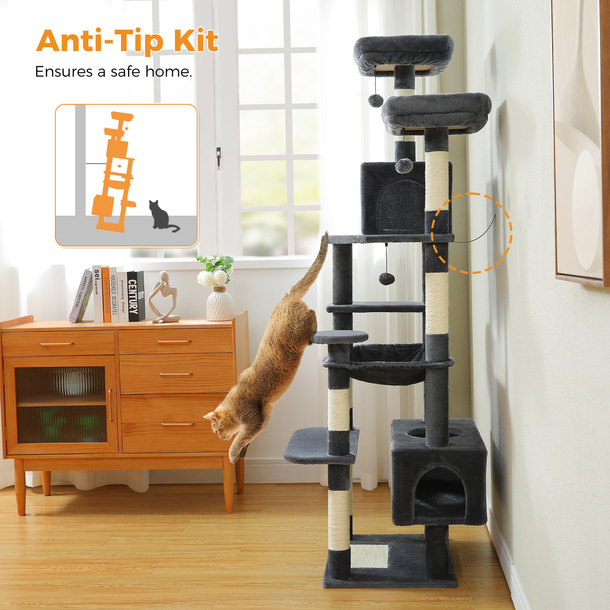 Dark-grey 184cm cat tree in a living room with ginger tabby leaping on it, anti-tip kit strap highlighted