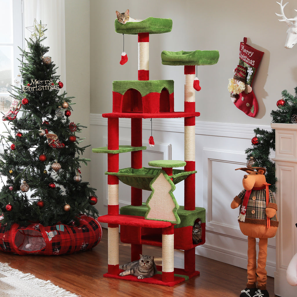 Red and green festive cat tower in a Christmas room, tabbies on the top perch and base, one peeking from a cubby