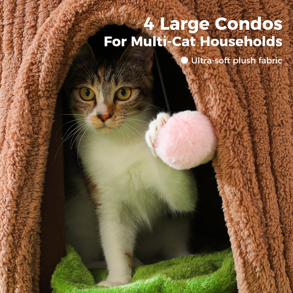 Tricolor cat peeking from an arched condo on the brown cat tree, batting a pink pom-pom hanging at the entrance